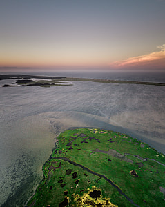 high angle photography of a body of water and island thumbnail