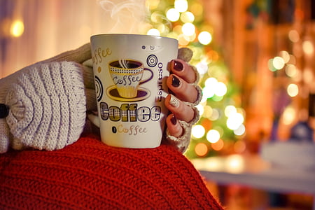 woman holding white ceramic coffee mug thumbnail
