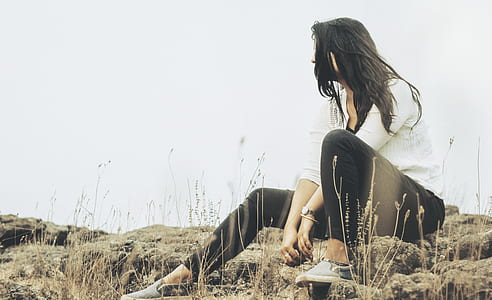 woman sitting on rocks thumbnail