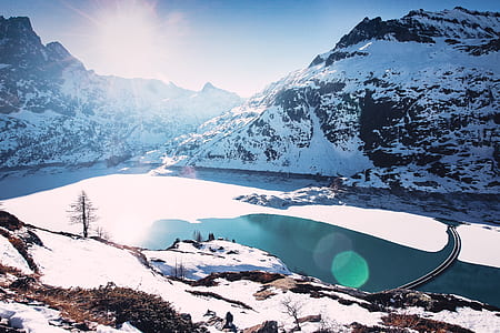 aerial photography of mountain and body of water thumbnail