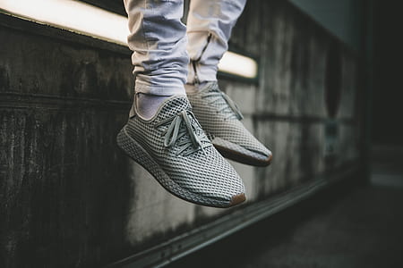 closeup photo of person wearing pair of gray running shoes thumbnail