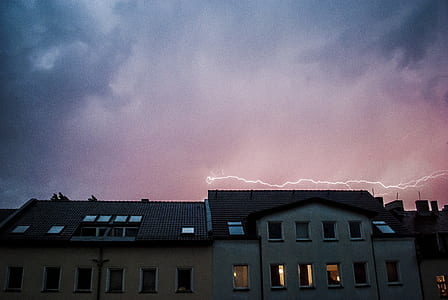 gray and brown concrete house during cloudy day thumbnail