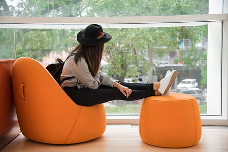 Woman Sitting on Orange Chair thumbnail