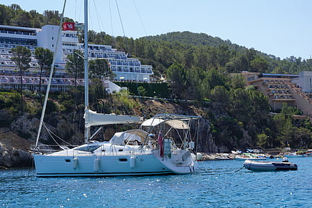 white bowrider boat near cliff thumbnail