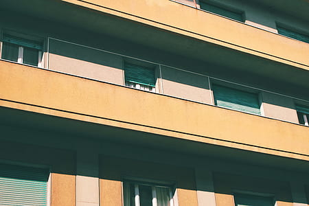 white and brown painted building in low angle photography thumbnail