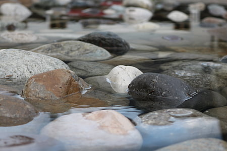selective focus photography of gray and black stone on river during daytime thumbnail