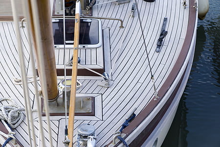 white and brown boat on body of water thumbnail