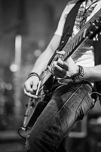 grayscale photo of person holding guitar thumbnail
