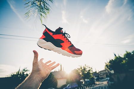 person throwing orange and white shoe thumbnail