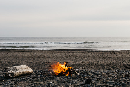 painting of bonfire near on seat shore thumbnail