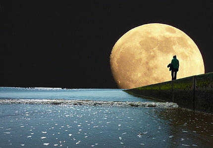silhouette person staring at the full moon thumbnail