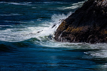mountain beside sea during day thumbnail