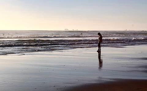 person standing beside sea thumbnail