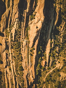 aerial photography of brown rock mountain and trees during daytime thumbnail