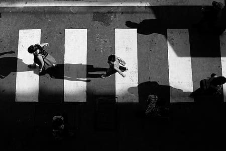 grayscale photography of person walking on road thumbnail