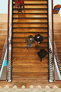 three men walking on brown wooden stairs thumbnail