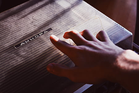 person touching gray box thumbnail