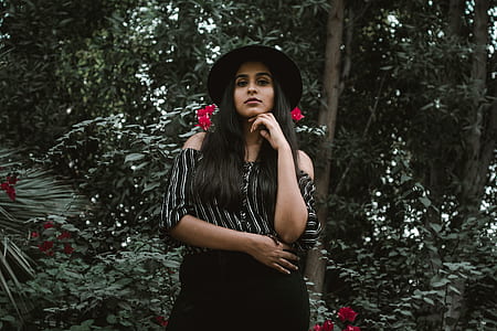 woman standing under trees taken at daytime thumbnail