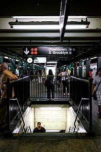 man standing beside rail thumbnail
