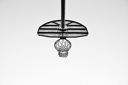 low angle photography of basketball system under cloudy skies thumbnail