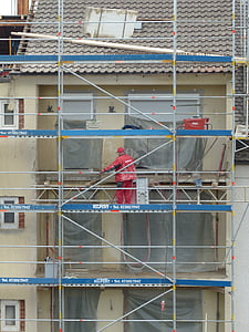 man on white scaffolding during daytime thumbnail