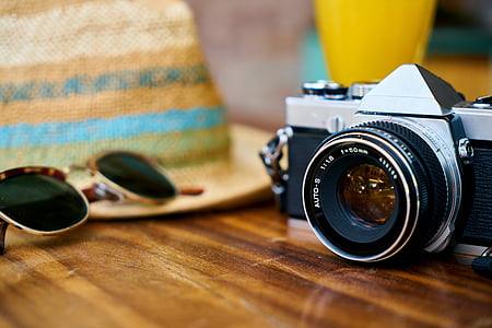 black and gray camera near the sunglasses on table thumbnail