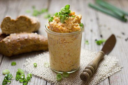 meat in glass with scallions beside brown wooden knife on table thumbnail