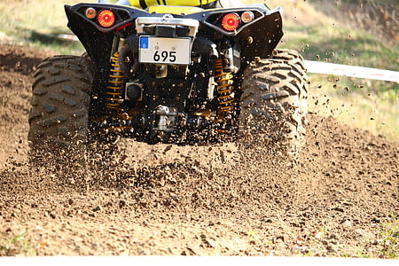 yellow and black ATV on mud thumbnail