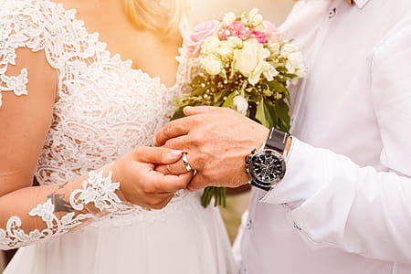 Close up Bride Put the Wedding Ring on groom. Romantic atmosphere thumbnail