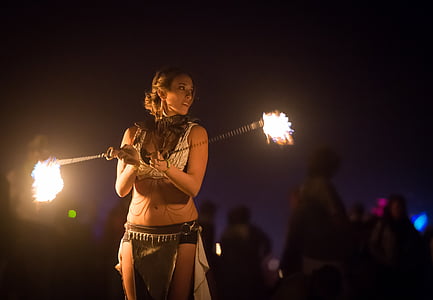 a woman fire dancing in night time thumbnail