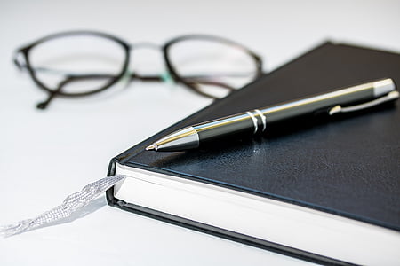 black pen on top of black book thumbnail