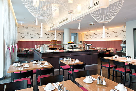 buffet room with brown wooden dining tables thumbnail