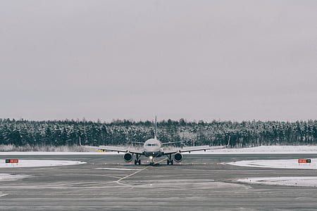 gray airliner on concrete pavement thumbnail