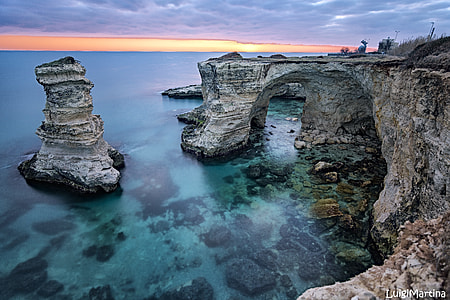 gray rock formation over body of water thumbnail