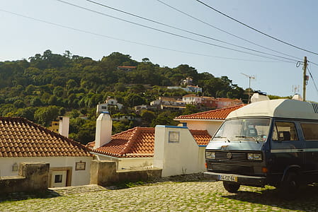 Parked Van Near Concrete House thumbnail