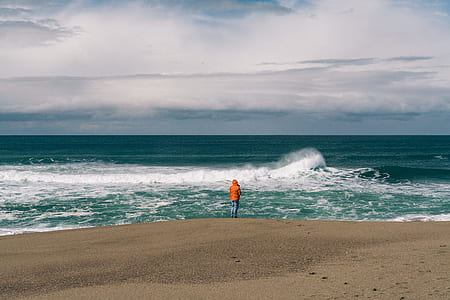 person standing near ocean thumbnail