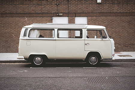 white van on gray concrete road during daytime thumbnail