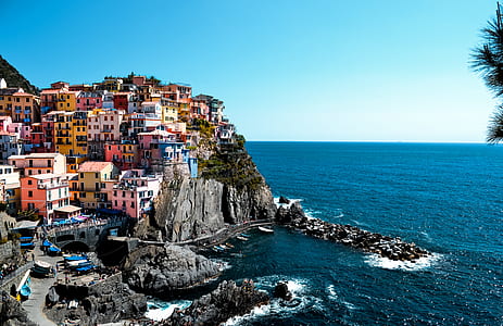 multicolored houses near body of water thumbnail
