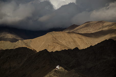 brown and black mountains under white clouds during daytime thumbnail