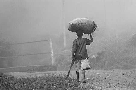 grayscale photography of man holding sack thumbnail
