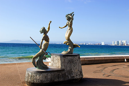 brown concrete mermaid statues during daytime thumbnail