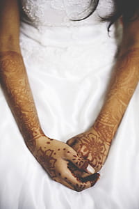 woman in white wedding gown with bridal mehndi tattoo thumbnail