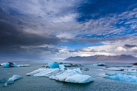 iceberg near mountain at daytime thumbnail