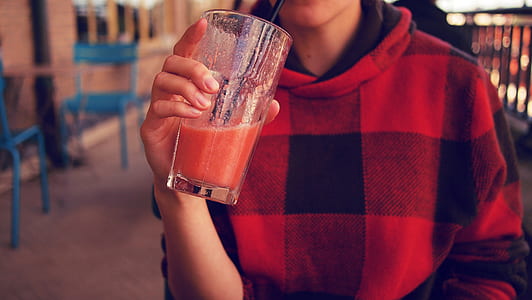 person holding clear drinking glass thumbnail