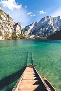 brown wooden stairs near body of water and ice-capped mountain during daytime thumbnail
