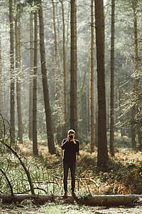 man holding camera standing on tree thumbnail