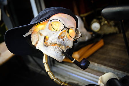 human skull decor with eyeglasses, cap, and tobacco pipe thumbnail