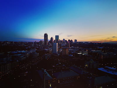 aerial view of busy city under blue sky thumbnail