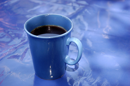 blue ceramic mug filled with brown liquid thumbnail
