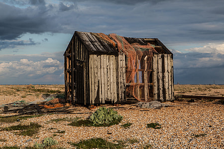 An abandoned old shack sits on the coast of Dungeness in Kent, England thumbnail